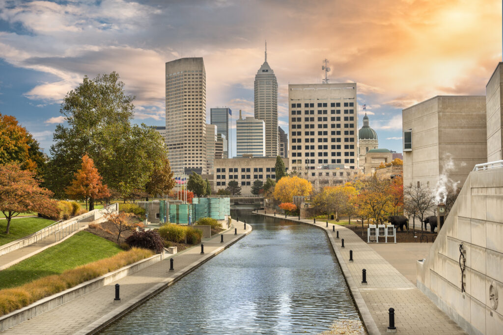 Downtown city skyline view of Indianapolis, Indiana, USA looking over the buildings and waters of the Central Canal Walk