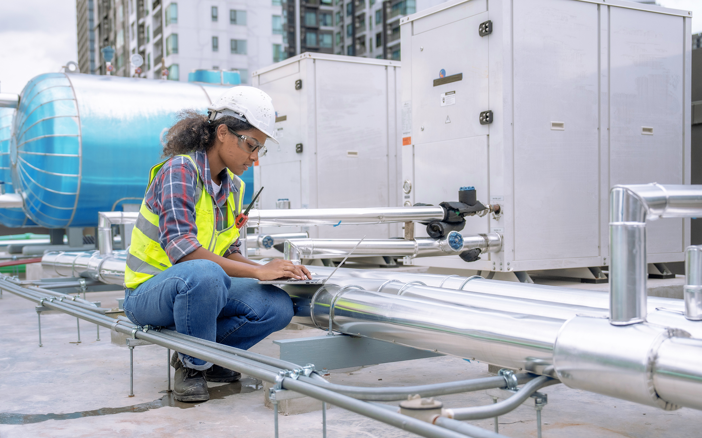 Female engineer inspects and controls the cooling system of a la