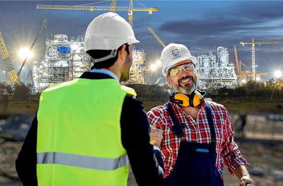 Industrial workers shaking hands at project site