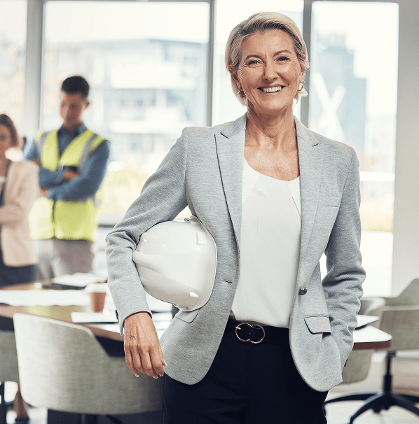 Executive holding hard hat in project planning meeting