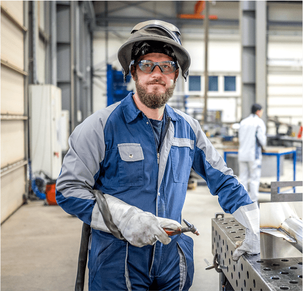 Welder working at fabrication shop workstation