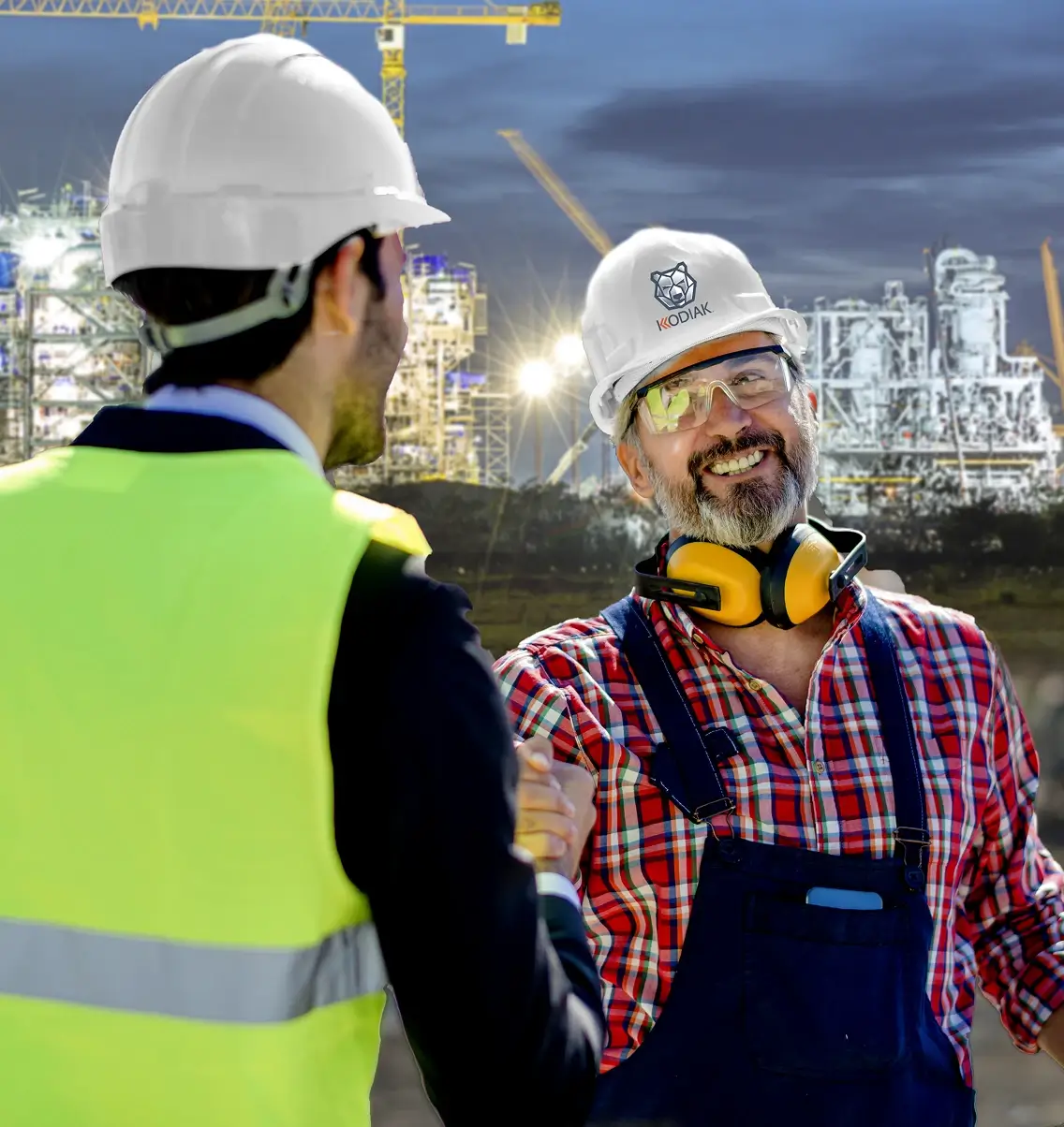 Two site personnel greeting at industrial facility