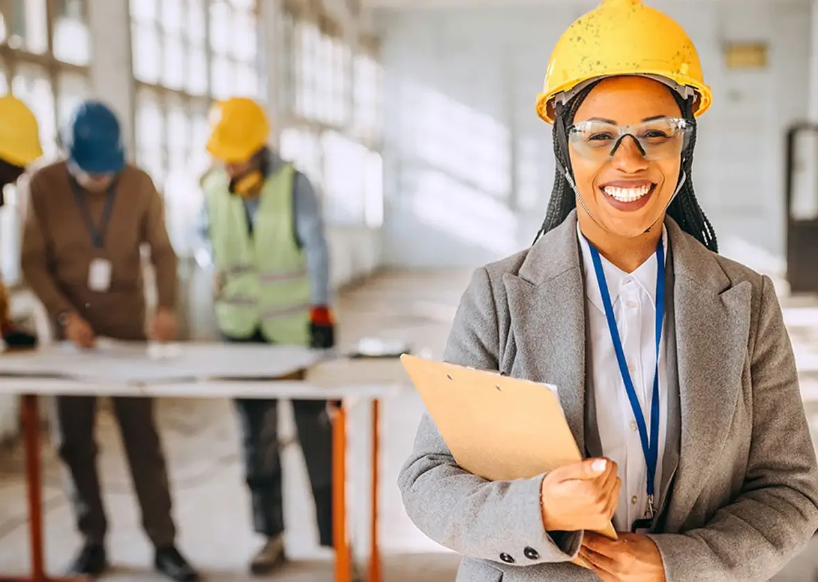 Construction manager holding project documents at a site during work